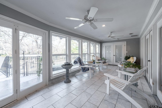 sunroom / solarium featuring ceiling fan