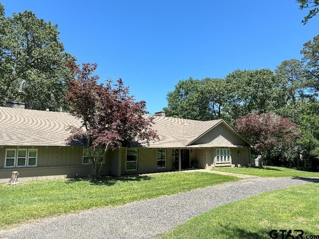 ranch-style home with a front lawn