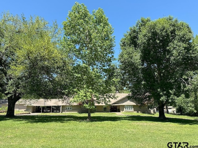 ranch-style house with a front lawn