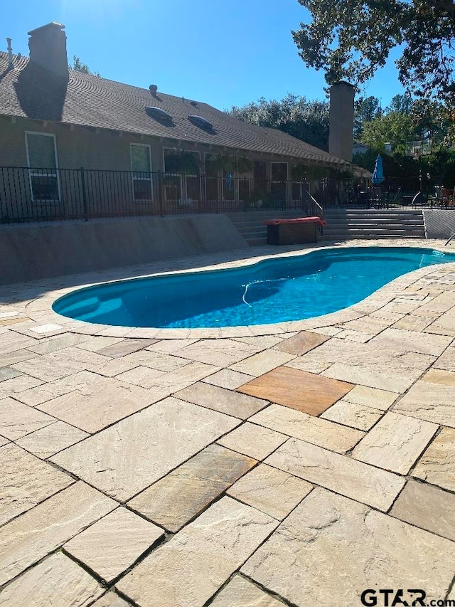 view of pool featuring a patio