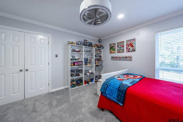 bedroom featuring crown molding, carpet floors, and a closet