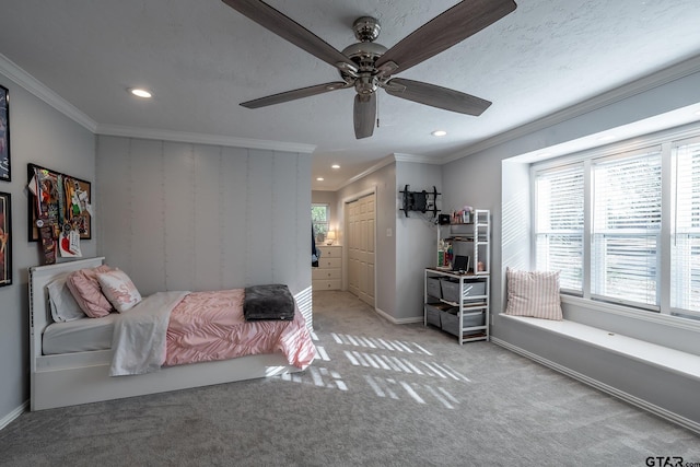 carpeted bedroom with multiple windows, ornamental molding, and ceiling fan