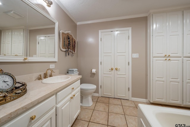 bathroom with vanity, crown molding, tile patterned floors, and toilet