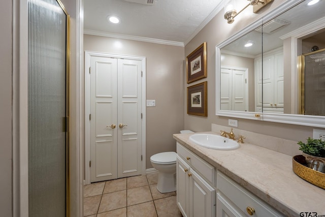 bathroom with a shower with shower door, tile patterned flooring, vanity, toilet, and crown molding