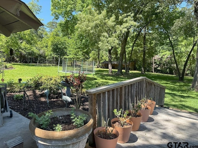 408 Cumberland Rd, Tyler, TX 75703 - view of patio with a trampoline and view of wooded area