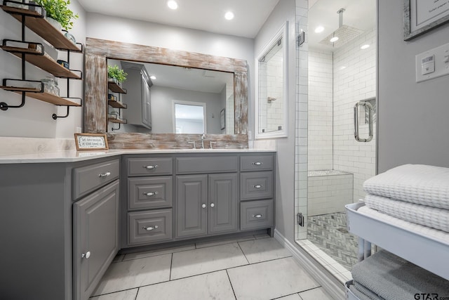 bathroom with vanity, tile patterned flooring, and a shower with door