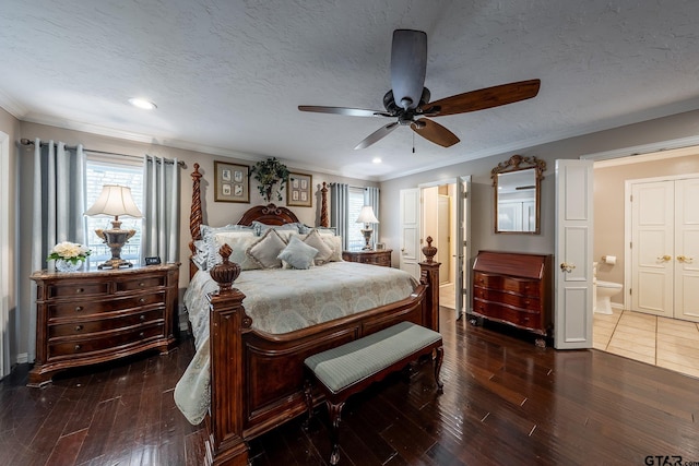 bedroom featuring a textured ceiling, dark wood-type flooring, ceiling fan, and ensuite bathroom