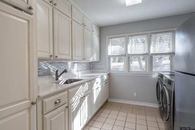 408 Cumberland Rd, Tyler, TX 75703 - laundry room with cabinet space, washer and dryer, light tile patterned floors, and baseboards
