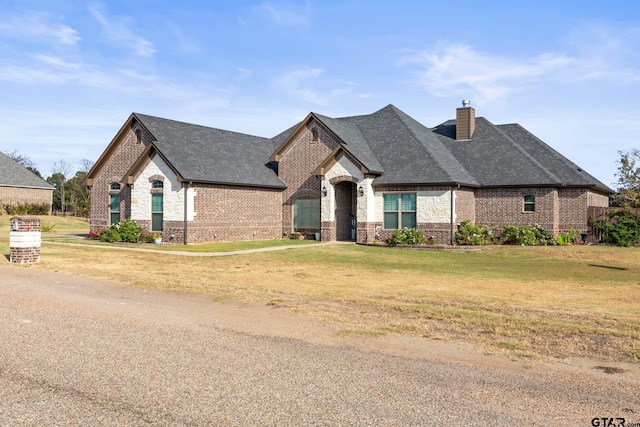 french provincial home with a front lawn