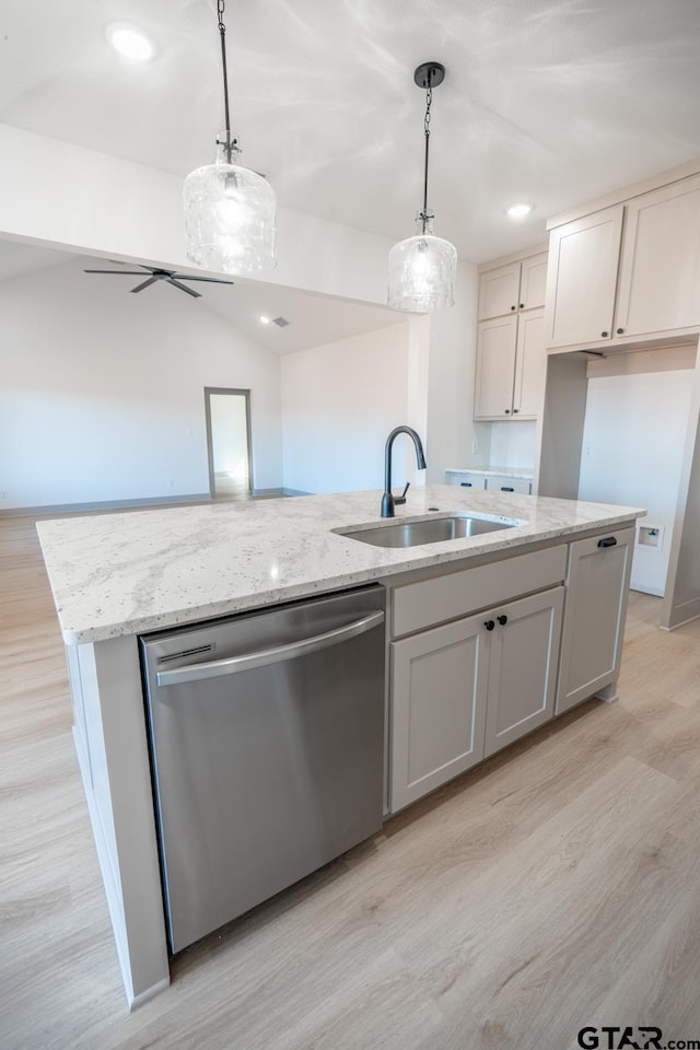 kitchen featuring sink, stainless steel dishwasher, an island with sink, white cabinets, and pendant lighting