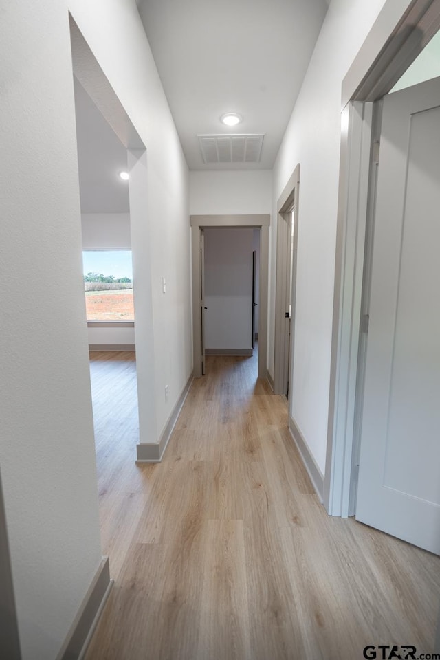 hallway with light wood-type flooring