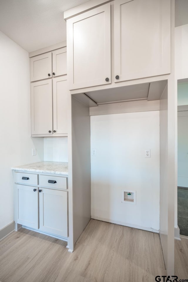 laundry room with light hardwood / wood-style flooring