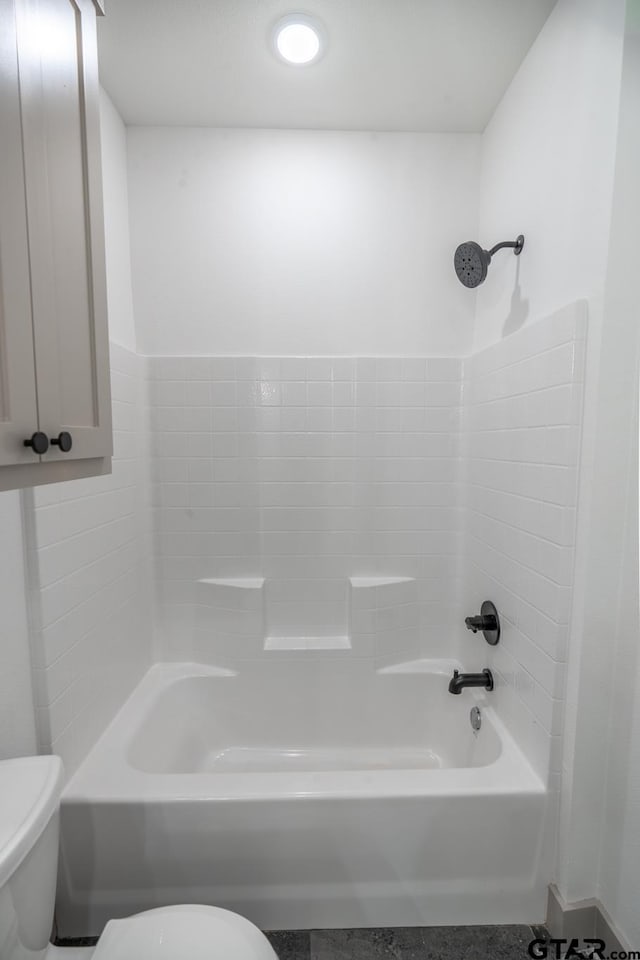 bathroom featuring shower / bathing tub combination and toilet