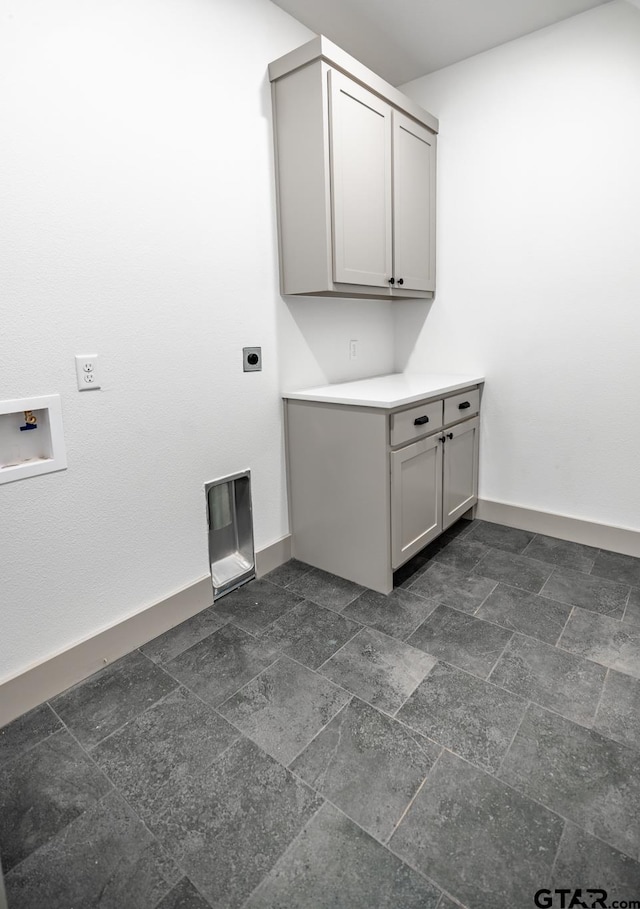 laundry room featuring hookup for an electric dryer, washer hookup, and cabinets