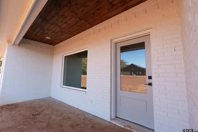 doorway to property with a patio area