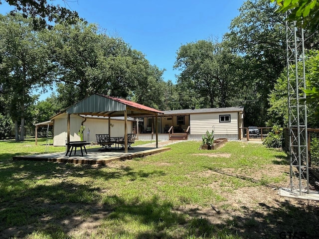 rear view of property with a patio and a yard