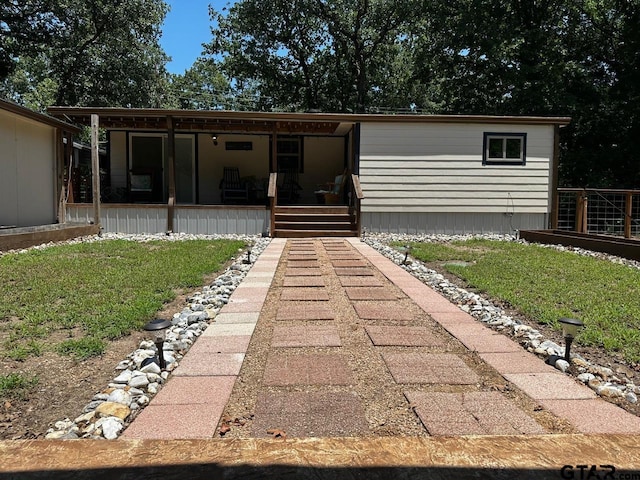 rear view of property featuring covered porch