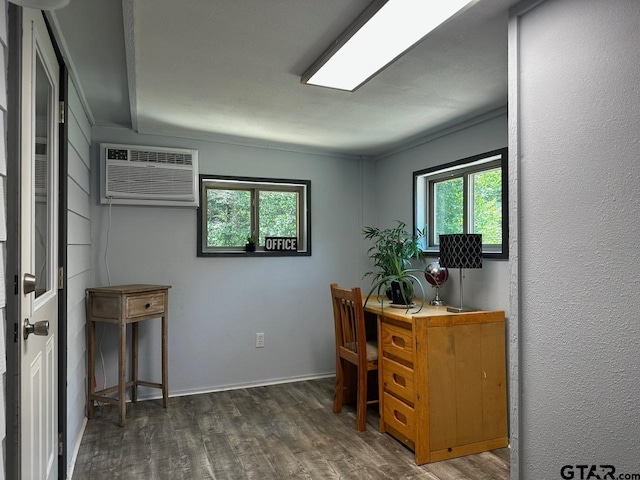 office space with dark hardwood / wood-style flooring and a wall unit AC