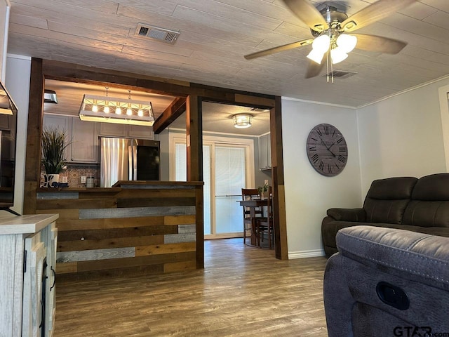 living room featuring hardwood / wood-style floors, ceiling fan, crown molding, and wood ceiling