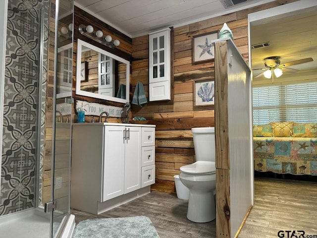 bathroom with vanity, an enclosed shower, hardwood / wood-style flooring, toilet, and ceiling fan