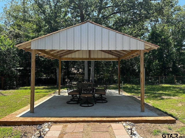 view of property's community featuring a patio, a lawn, and a gazebo