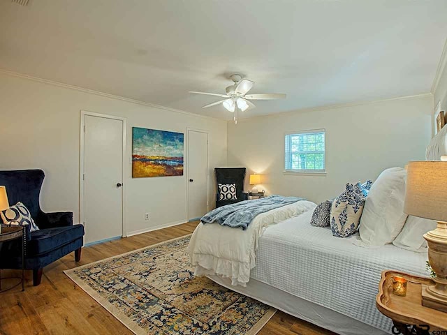 bedroom with wood-type flooring, ceiling fan, and ornamental molding