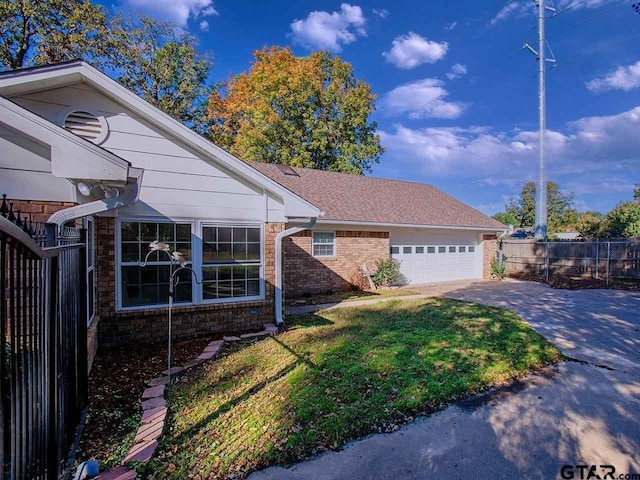 704 Wellington St, Tyler, TX 75703 - view of front of house with brick siding, concrete driveway, and an attached garage