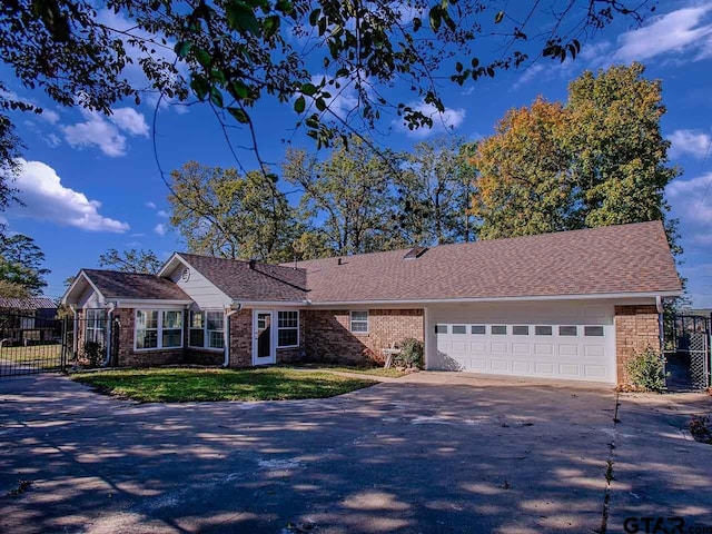 single story home featuring a front lawn and a garage