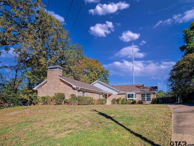 ranch-style home with a front lawn