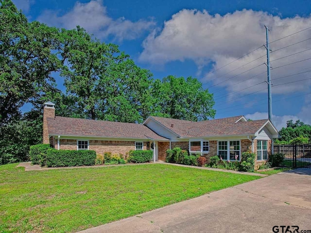 704 Wellington St, Tyler, TX 75703 - ranch-style house featuring a chimney and brick siding