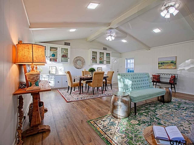 living room with lofted ceiling with beams, ceiling fan, and wood-type flooring