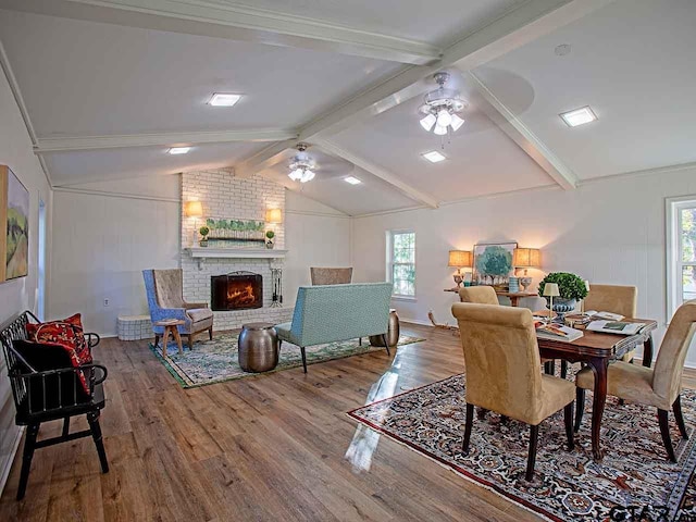 dining space featuring lofted ceiling with beams, ceiling fan, a healthy amount of sunlight, and hardwood / wood-style flooring