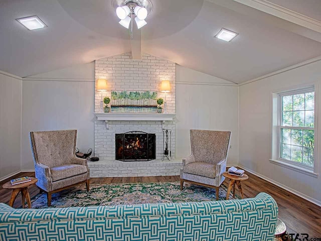 living area featuring hardwood / wood-style floors, a fireplace, and vaulted ceiling