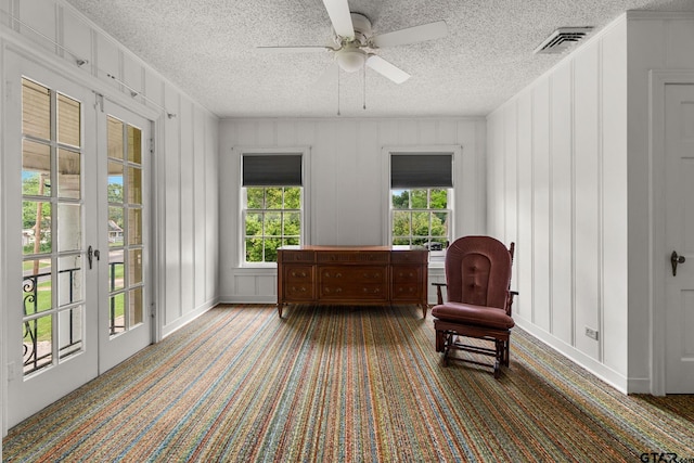 sitting room featuring a textured ceiling, ceiling fan, and french doors