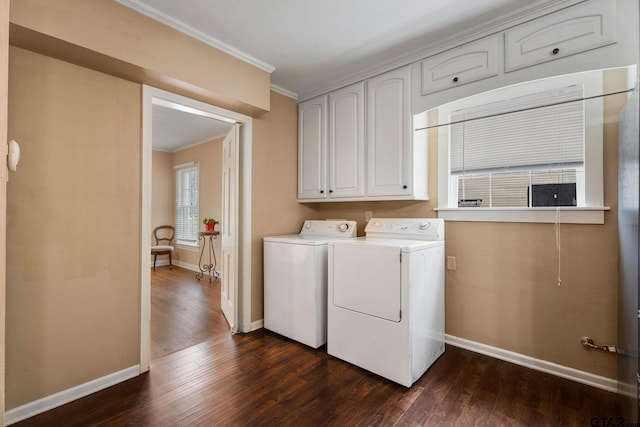 clothes washing area featuring cabinets, dark hardwood / wood-style floors, crown molding, and washing machine and clothes dryer