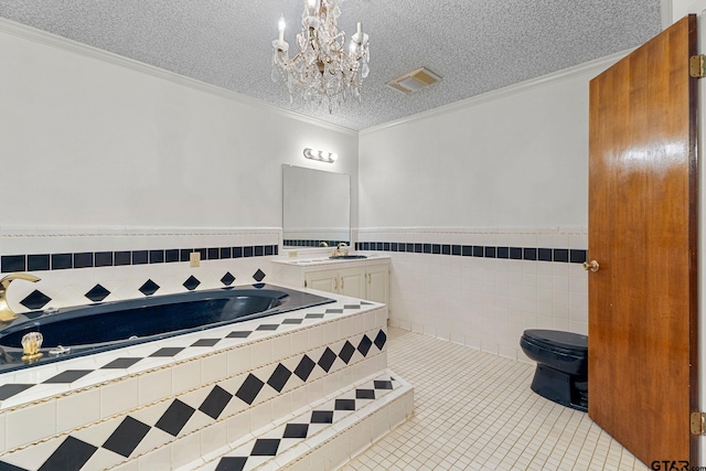 bathroom with tile walls, a chandelier, a textured ceiling, tiled tub, and crown molding