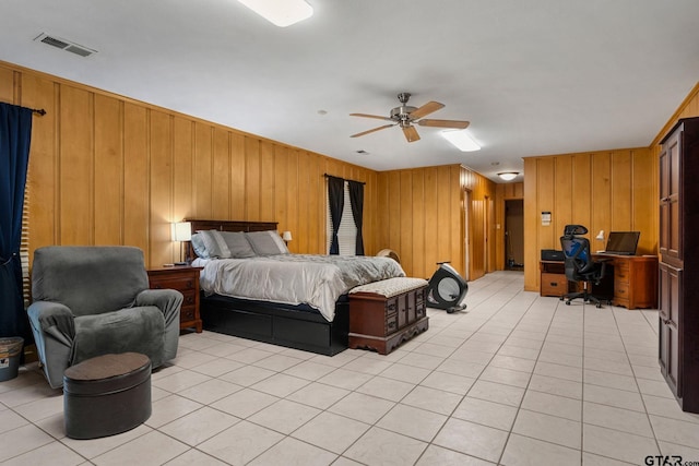 bedroom with light tile patterned flooring, ceiling fan, and wooden walls