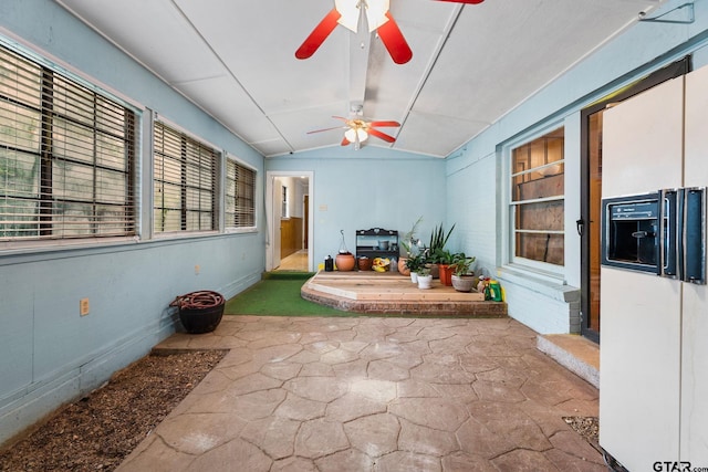 sunroom with lofted ceiling and ceiling fan