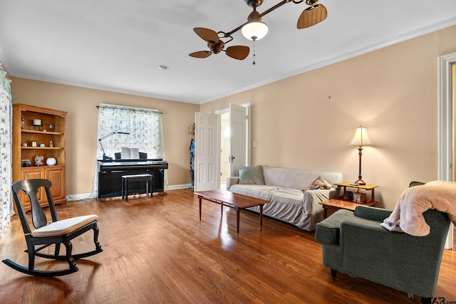 living room featuring wood-type flooring, ceiling fan, and crown molding