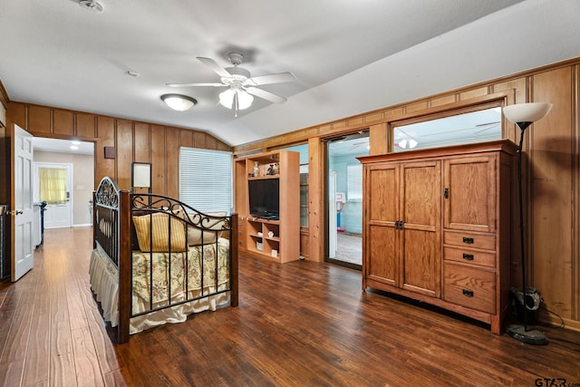 bedroom featuring ceiling fan, dark hardwood / wood-style floors, and lofted ceiling