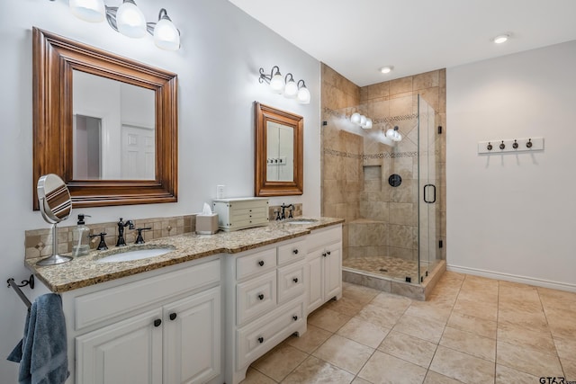 bathroom featuring tile patterned flooring, an enclosed shower, and vanity