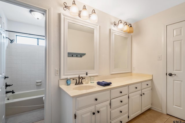 bathroom featuring tile patterned floors, vanity, and tiled shower / bath