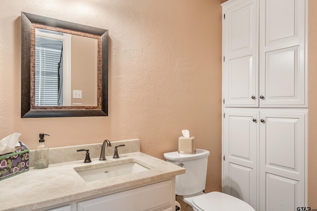 bathroom featuring toilet and vanity