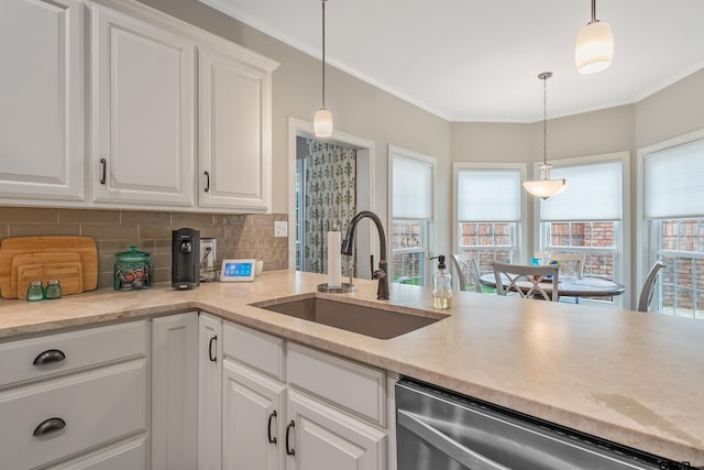 kitchen with stainless steel dishwasher, decorative light fixtures, sink, and white cabinets