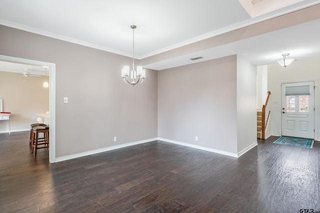 unfurnished room featuring dark hardwood / wood-style flooring, crown molding, and a notable chandelier