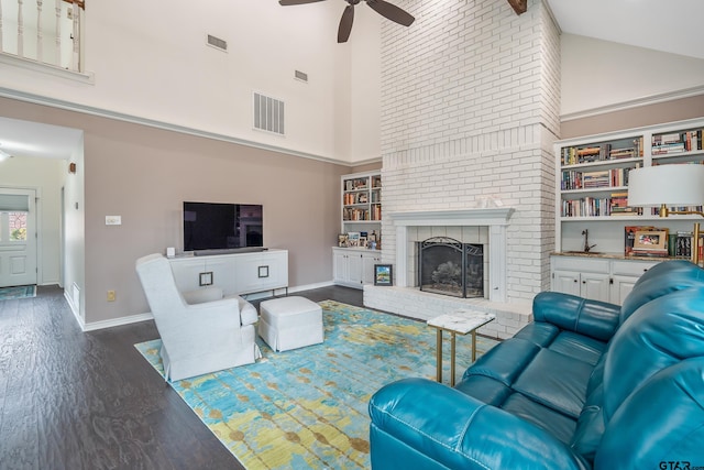 living room with ceiling fan, high vaulted ceiling, dark hardwood / wood-style flooring, and a fireplace