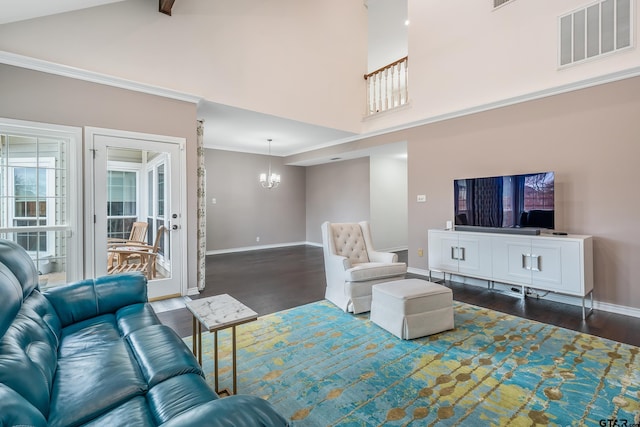 living room featuring ornamental molding, dark wood-type flooring, high vaulted ceiling, and a notable chandelier