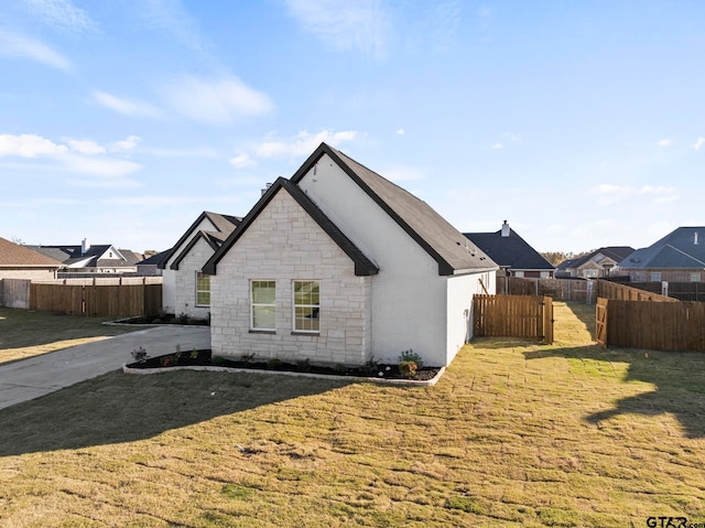 rear view of property featuring a lawn