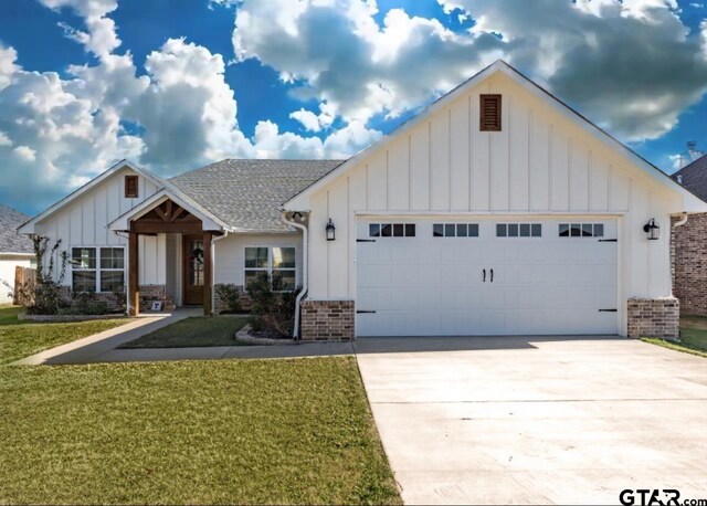 view of front of property featuring a garage and a front lawn