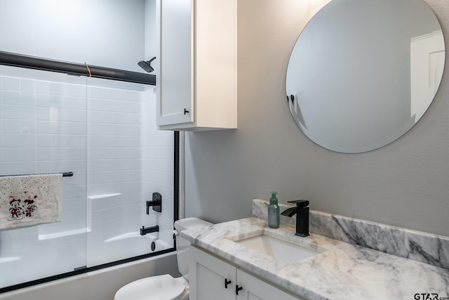 full bathroom featuring toilet, vanity, and enclosed tub / shower combo